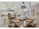 Open concept dining area featuring stylish chairs, pendant lighting, open concept kitchen and decor at 6766 Beedla St, North Port, FL 34291