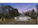 Charming one-story home featuring an attached garage, well-maintained landscaping, and a spacious front yard at 6766 Beedla St, North Port, FL 34291
