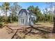Two-story home with covered porch and deck surrounded by mature trees at 6766 Beedla St, North Port, FL 34291