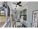 Cozy, screened-in front porch features rocking chairs, lovely decor, and beautiful natural light at 6766 Beedla St, North Port, FL 34291