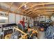 Well organized garage featuring a new lawn mower and other yard tools at 6766 Beedla St, North Port, FL 34291