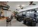 Spacious garage with golf carts, work bench, bar stools, and ample ceiling lighting at 6766 Beedla St, North Port, FL 34291