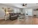 Spacious living room featuring wood floors, comfortable seating, a ceiling fan, and lots of natural light at 6766 Beedla St, North Port, FL 34291