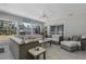 Bright living room with wicker furniture and large windows offering abundant natural light at 6766 Beedla St, North Port, FL 34291