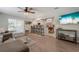 Open concept living room featuring wood floors, modern furnishings, and an adjoining kitchen area at 6766 Beedla St, North Port, FL 34291