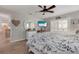 Cozy main bedroom featuring wood-look flooring, a large window and a decorative mirror at 6766 Beedla St, North Port, FL 34291