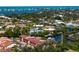 Scenic aerial view of a waterfront community featuring canal-front homes, mature trees, and glimpses of the ocean at 709 Sorrento Inlt # 709, Nokomis, FL 34275