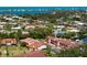 Scenic aerial view of a residential community with canal-front homes, lush trees, and blue ocean water in the distance at 709 Sorrento Inlt # 709, Nokomis, FL 34275