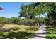 Beautiful backyard with a lush lawn and pathway leading to a private community dock at 709 Sorrento Inlt # 709, Nokomis, FL 34275
