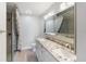 Bathroom featuring double sinks, granite countertops, modern fixtures, and an enclosed shower at 709 Sorrento Inlt # 709, Nokomis, FL 34275