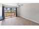 Bright bedroom featuring light wood floors and sliding glass doors with patio views at 709 Sorrento Inlt # 709, Nokomis, FL 34275