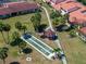 Aerial view showcasing shuffleboard, gazebo, palm trees, and manicured lawns in condo community at 709 Sorrento Inlt # 709, Nokomis, FL 34275