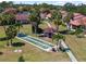 Aerial view showcasing shuffleboard, gazebo, palm trees, and manicured lawns in condo community at 709 Sorrento Inlt # 709, Nokomis, FL 34275