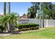 The Sorrento Inlet community sign set in a lush green lawn with beautiful landscaping and a glimpse of red roofs beyond at 709 Sorrento Inlt # 709, Nokomis, FL 34275