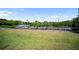 Community dock with boat slips and canal access, set against a green lawn at 709 Sorrento Inlt # 709, Nokomis, FL 34275
