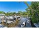 Picturesque waterfront view of a boat at a dock amidst lush greenery at 709 Sorrento Inlt # 709, Nokomis, FL 34275
