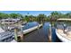 Picturesque waterfront view of boats at the community dock amidst lush greenery at 709 Sorrento Inlt # 709, Nokomis, FL 34275