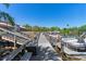 Community boat dock along the channel with boats parked on a sunny day at 709 Sorrento Inlt # 709, Nokomis, FL 34275