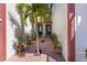 Charming entrance with palm trees and potted plants leading to front doors at 709 Sorrento Inlt # 709, Nokomis, FL 34275