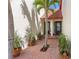 Charming front entrance featuring potted plants and a tiled walkway leading to the front door at 709 Sorrento Inlt # 709, Nokomis, FL 34275