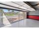 Spacious garage featuring epoxy flooring, red and gray painted walls, and an open view of the driveway at 709 Sorrento Inlt # 709, Nokomis, FL 34275