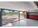 Spacious garage featuring epoxy flooring, red and gray painted walls, and an open view of the driveway at 709 Sorrento Inlt # 709, Nokomis, FL 34275
