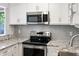 Updated kitchen featuring stainless steel microwave and range, with granite countertops at 709 Sorrento Inlt # 709, Nokomis, FL 34275