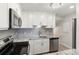 Beautiful kitchen boasts stainless steel appliances, granite countertops, and modern backsplash at 709 Sorrento Inlt # 709, Nokomis, FL 34275