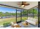 Screened lanai area offering seating and beautiful views of the canal and the lush greenery at 709 Sorrento Inlt # 709, Nokomis, FL 34275