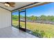 Screened lanai offering picturesque views of the lush backyard and dock at 709 Sorrento Inlt # 709, Nokomis, FL 34275