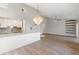Open-concept living space featuring a modern chandelier, open kitchen, and sleek shelving at 709 Sorrento Inlt # 709, Nokomis, FL 34275