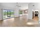Bright living room features wood floors, ceiling fan, and sliding glass doors to the outdoors at 709 Sorrento Inlt # 709, Nokomis, FL 34275