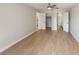 Spacious main bedroom featuring a ceiling fan, wood-look flooring, and ensuite bath and closet at 709 Sorrento Inlt # 709, Nokomis, FL 34275