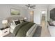Bright bedroom featuring a ceiling fan, ensuite bathroom access, and neutral tones at 709 Sorrento Inlt # 709, Nokomis, FL 34275