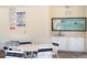 Poolside dining area with tables and chairs, complemented by pool rule signage at 709 Sorrento Inlt # 709, Nokomis, FL 34275