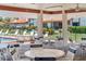 Poolside lounging and dining area with ample seating and views of lush landscaping at 709 Sorrento Inlt # 709, Nokomis, FL 34275