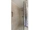 Modern shower features decorative tiling, stone floor, updated fixtures, and glass enclosure at 709 Sorrento Inlt # 709, Nokomis, FL 34275