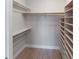 Walk-in closet with built-in shelving and hanging rods to maximize storage at 709 Sorrento Inlt # 709, Nokomis, FL 34275