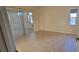 Bright bedroom with tile flooring, sliding glass doors leading to a sunroom, and a neutral color palette at 7102 52Nd E Dr, Bradenton, FL 34203