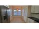 Cozy dining area with tile flooring, pendant lighting, and natural light from a window at 7102 52Nd E Dr, Bradenton, FL 34203