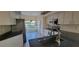 The kitchen features sleek countertops and modern appliances, including a stainless steel refrigerator at 7102 52Nd E Dr, Bradenton, FL 34203