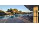 Community pool with lounge chairs and a lake in the background at 7102 52Nd E Dr, Bradenton, FL 34203