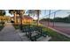 Picnic tables and playground area adjacent to a tennis court at 7102 52Nd E Dr, Bradenton, FL 34203