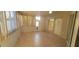 Enclosed sunroom featuring tile floors and large sliding glass doors at 7102 52Nd E Dr, Bradenton, FL 34203