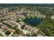 Sprawling aerial view of the community featuring a lake, mature trees, and neighborhood pool at 7118 Lakeside Dr # 7118, Sarasota, FL 34243