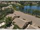 A beautiful aerial view of the homes, a lake, and a community pool surrounded by mature trees and lush landscaping at 7118 Lakeside Dr # 7118, Sarasota, FL 34243