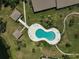 Aerial view of community pool with decorative shape, loungers, gazebo, and landscaping at 7118 Lakeside Dr # 7118, Sarasota, FL 34243