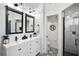 Stylish bathroom featuring double vanities, modern fixtures, and a glass-enclosed shower at 7118 Lakeside Dr # 7118, Sarasota, FL 34243