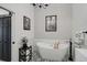 Modern bathroom features a freestanding tub, black accents, and black and white patterned tile flooring at 7118 Lakeside Dr # 7118, Sarasota, FL 34243