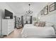 Bright bedroom with white decor, a patterned chair, and a stylish chandelier at 7118 Lakeside Dr # 7118, Sarasota, FL 34243